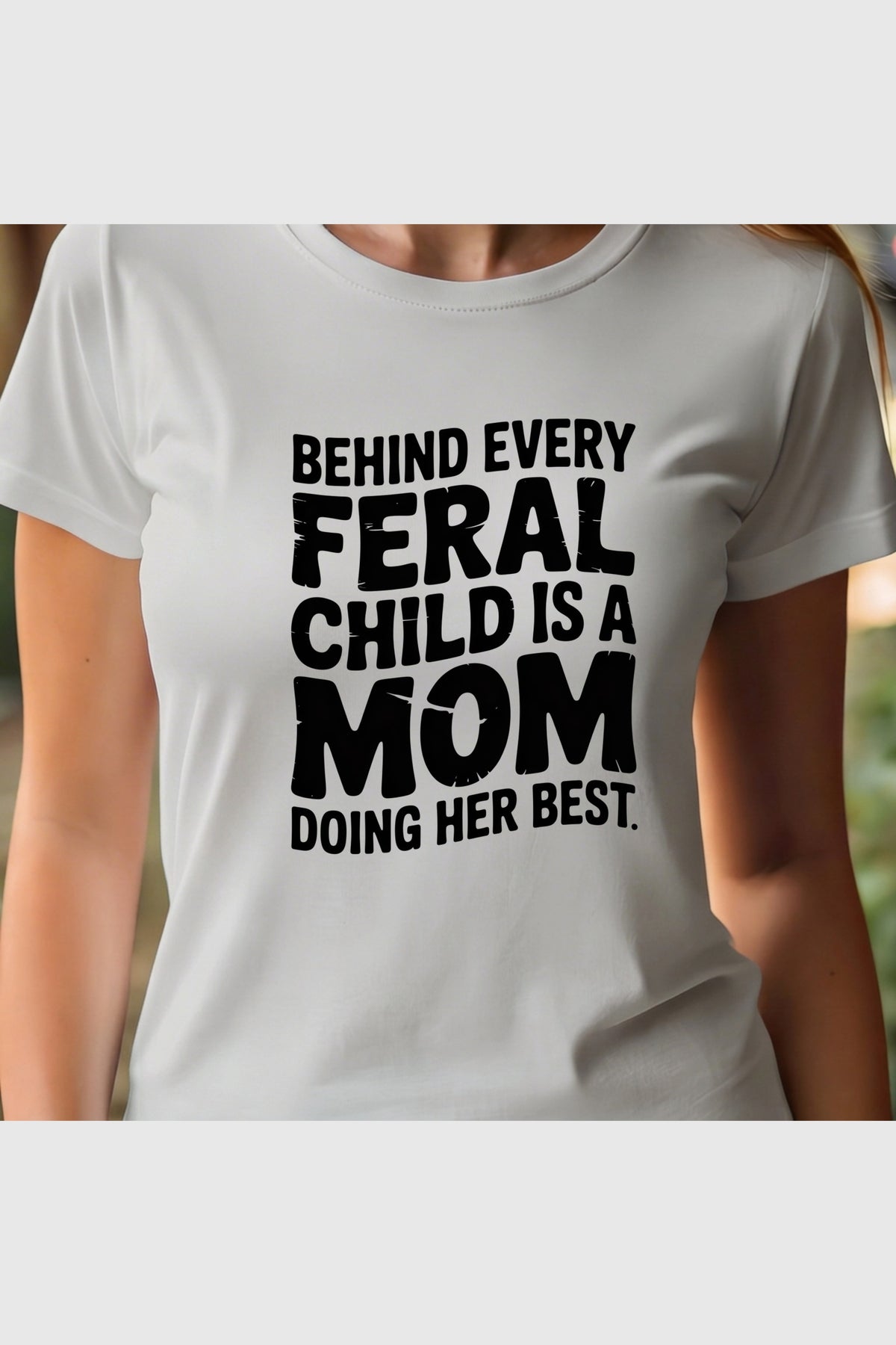 Woman wearing white Behind Every Feral Child Is a Mom t-shirt