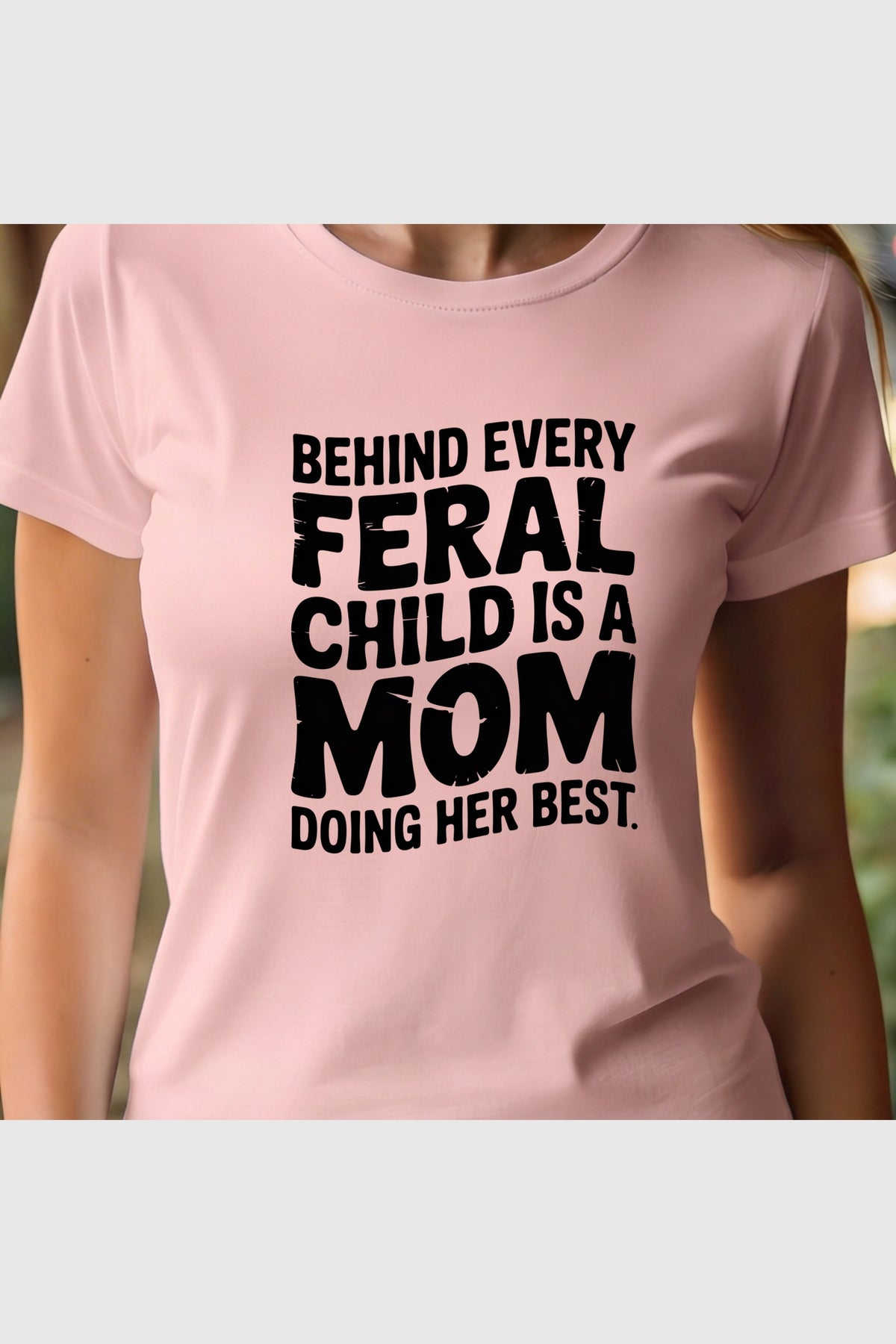 Woman wearing black Behind Every Feral Child Is a Mom t-shirt