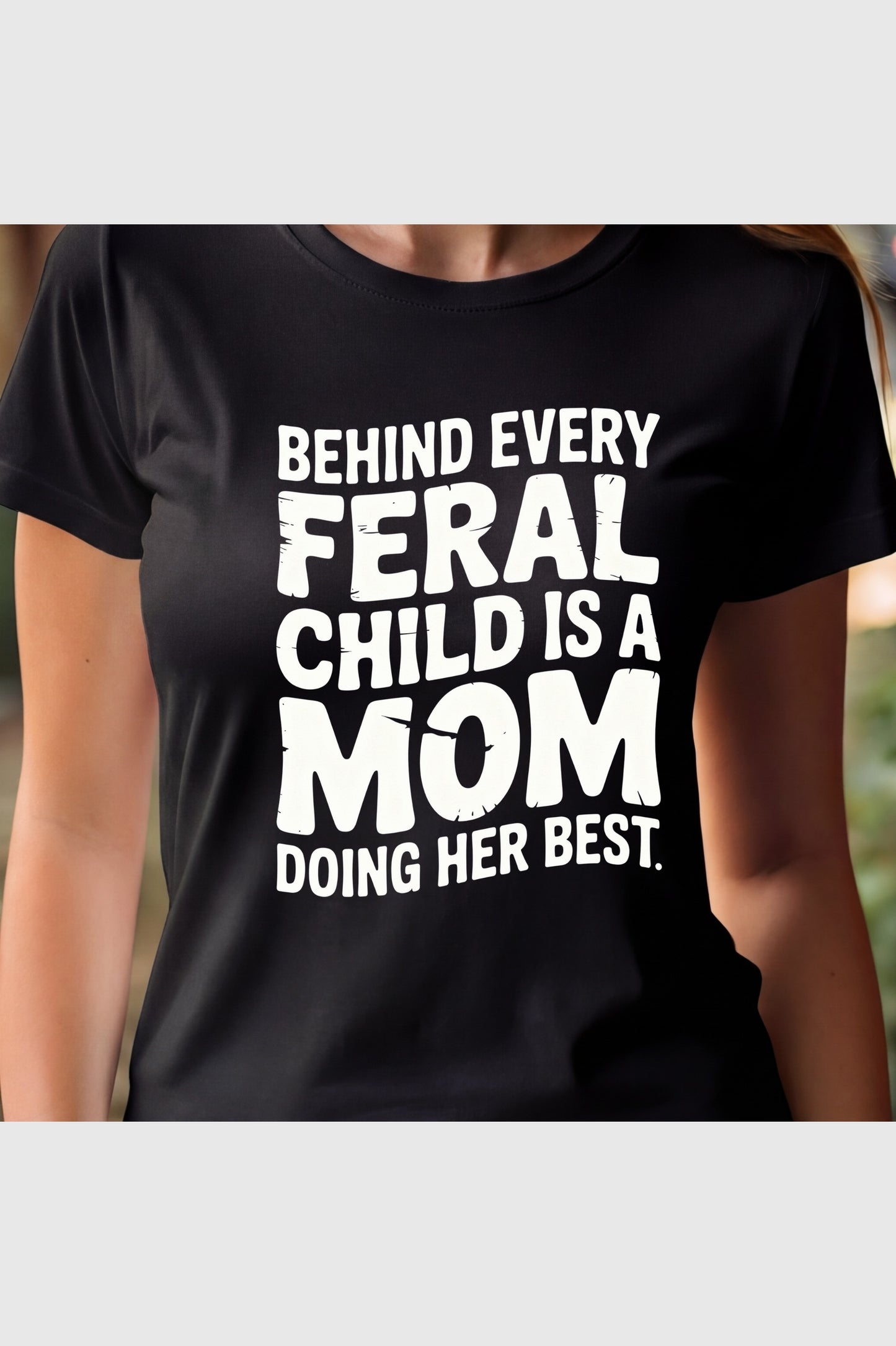 Man wearing black t-shirt with Feral Child Mom print