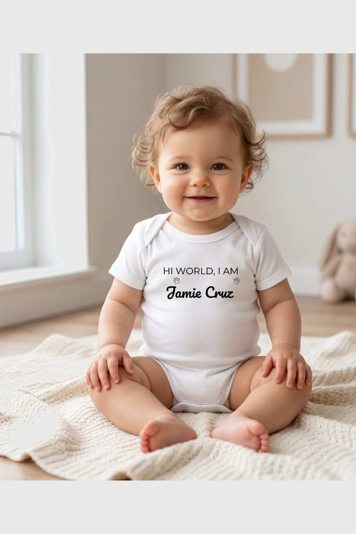 Baby wearing white Hi World personalized bodysuit, snap closure