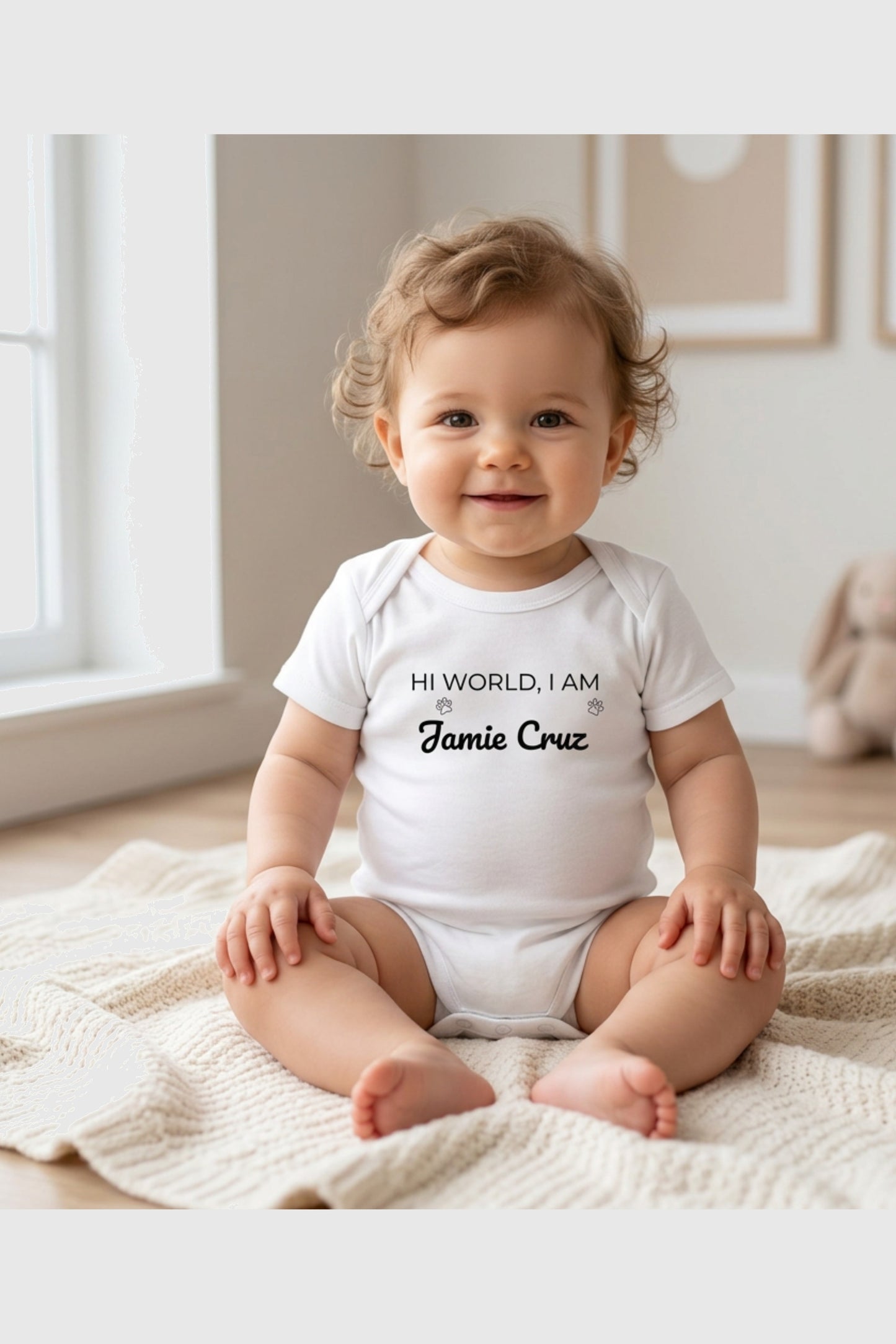 Baby wearing white Hi World personalized bodysuit, snap closure