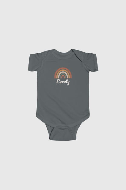Baby wearing yellow personalized rainbow bodysuit