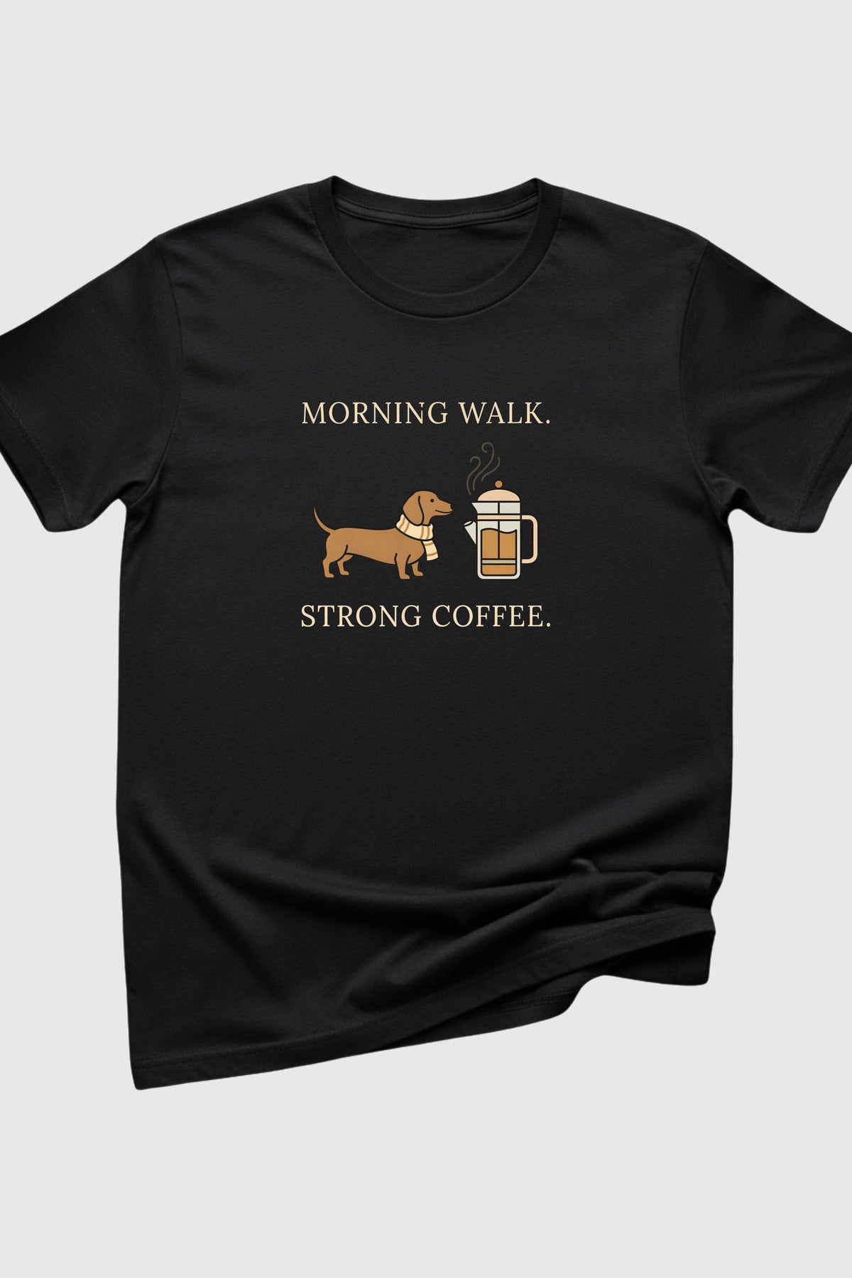 Black t-shirt with a dachshund and coffee graphic and text on a light gray background