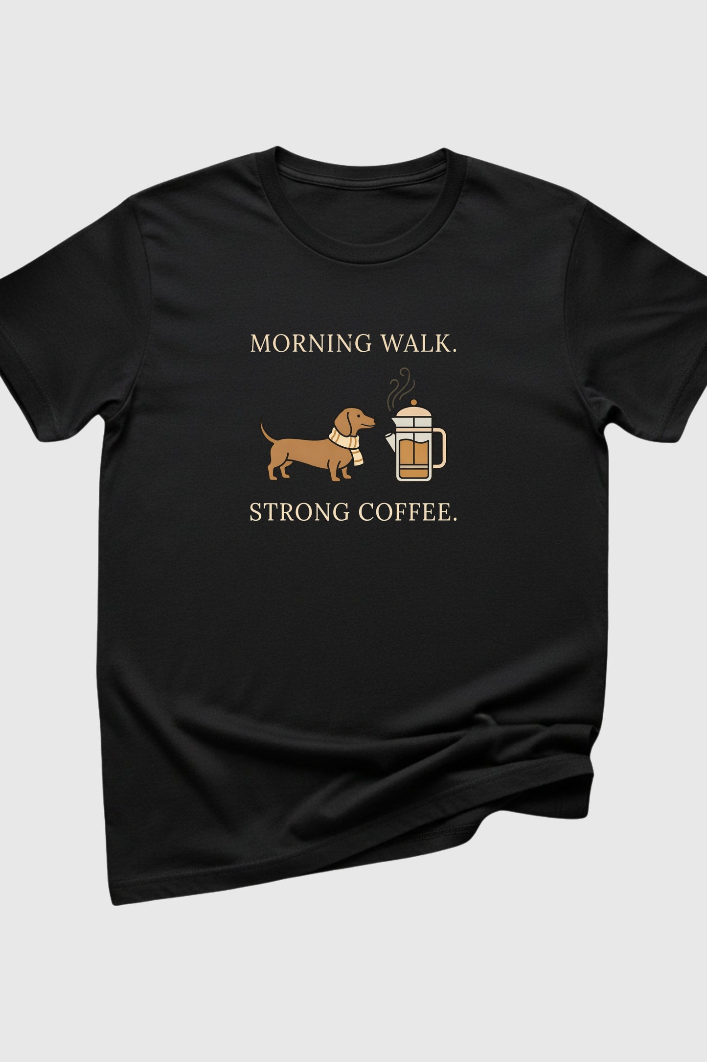 Black t-shirt with a dachshund and coffee graphic and text on a light gray background