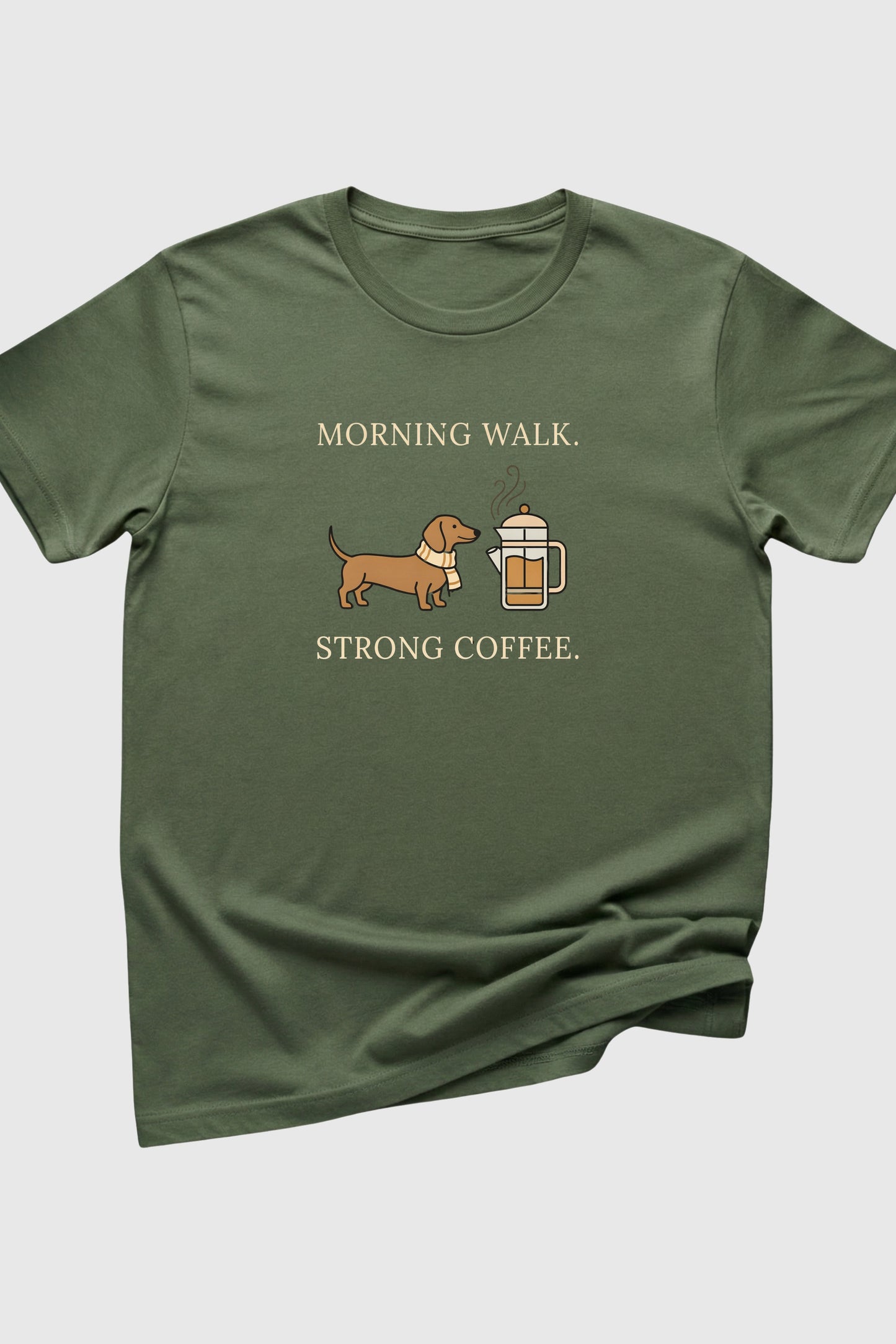 Green t-shirt with a dachshund and coffee cup graphic and text on a white background