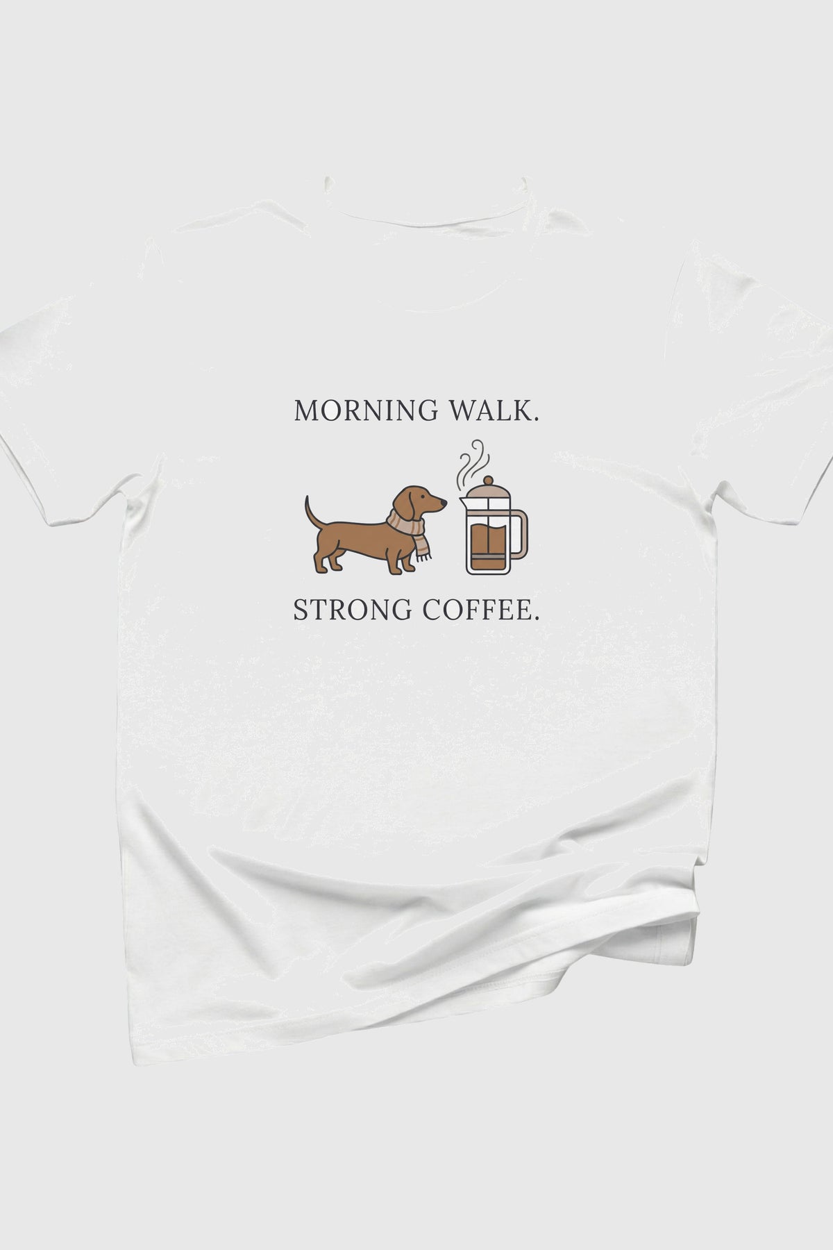 White t-shirt with a dachshund and coffee mug graphic and text on a white background