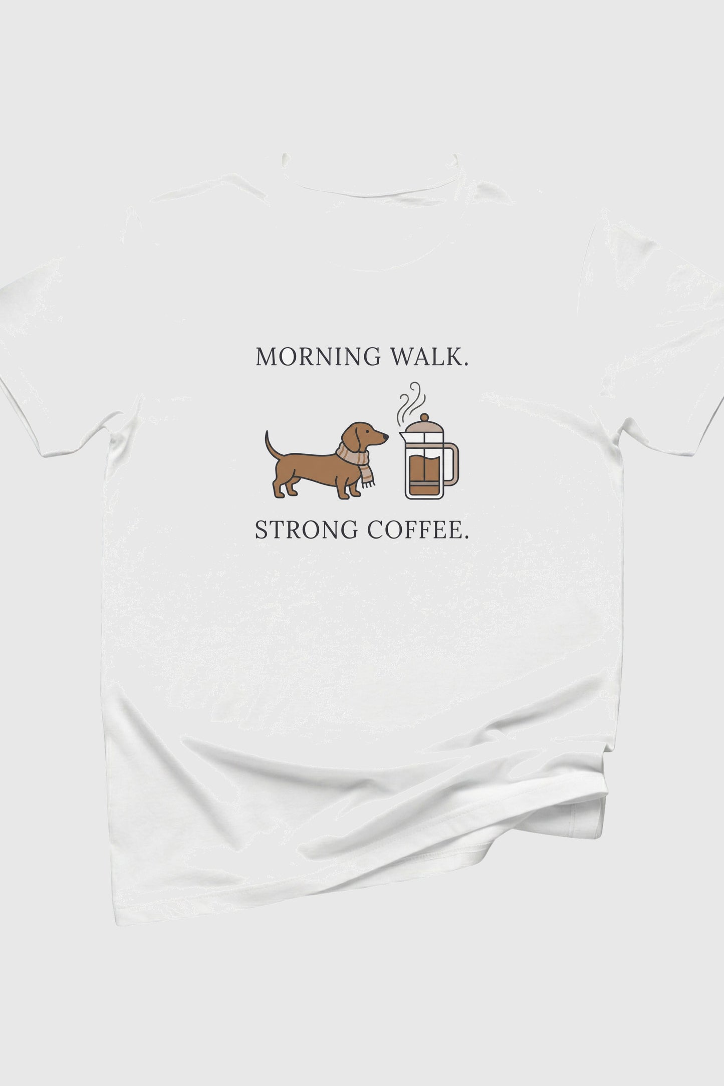 White t-shirt with a dachshund and coffee mug graphic and text on a white background