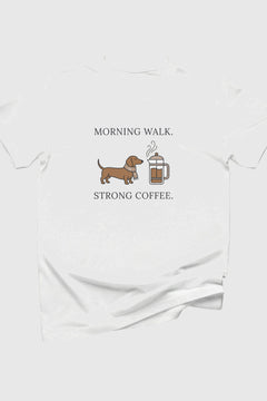 White t-shirt with a dachshund and coffee mug graphic and text on a white background