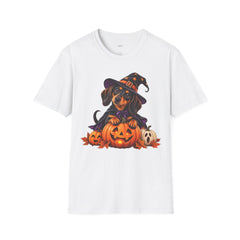 A white short-sleeve crewneck t-shirt featuring a colorful graphic print of a dachshund dressed as a witch sitting among jack-o'-lanterns, displayed on a clean white background.