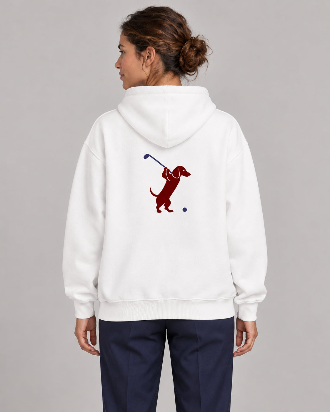 Woman wearing Club & Swing dachshund golf hoodie, back studio view. Color: White