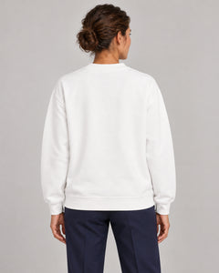 Woman wearing Swing dachshund golf sweatshirt, back studio view. Color: White
