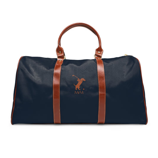 Color: Navy. Swing Dachshund golf travel bag in navy with a brown swinging dachshund and MVM monogram on the front, brown PU handles, front view.