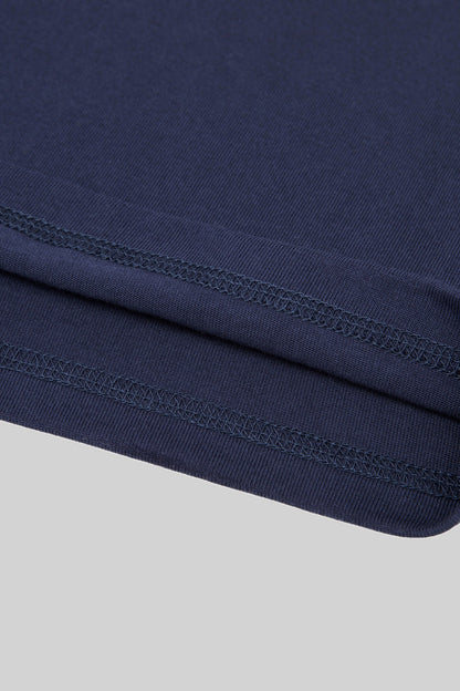 Double-stitched hem of the navy heavyweight cotton tee, close-up