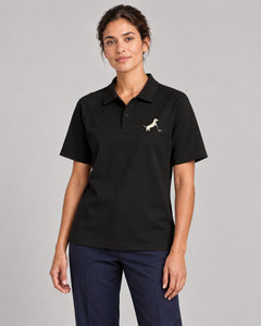 Woman wearing Putting dachshund golf polo, front studio view. Color: Black
