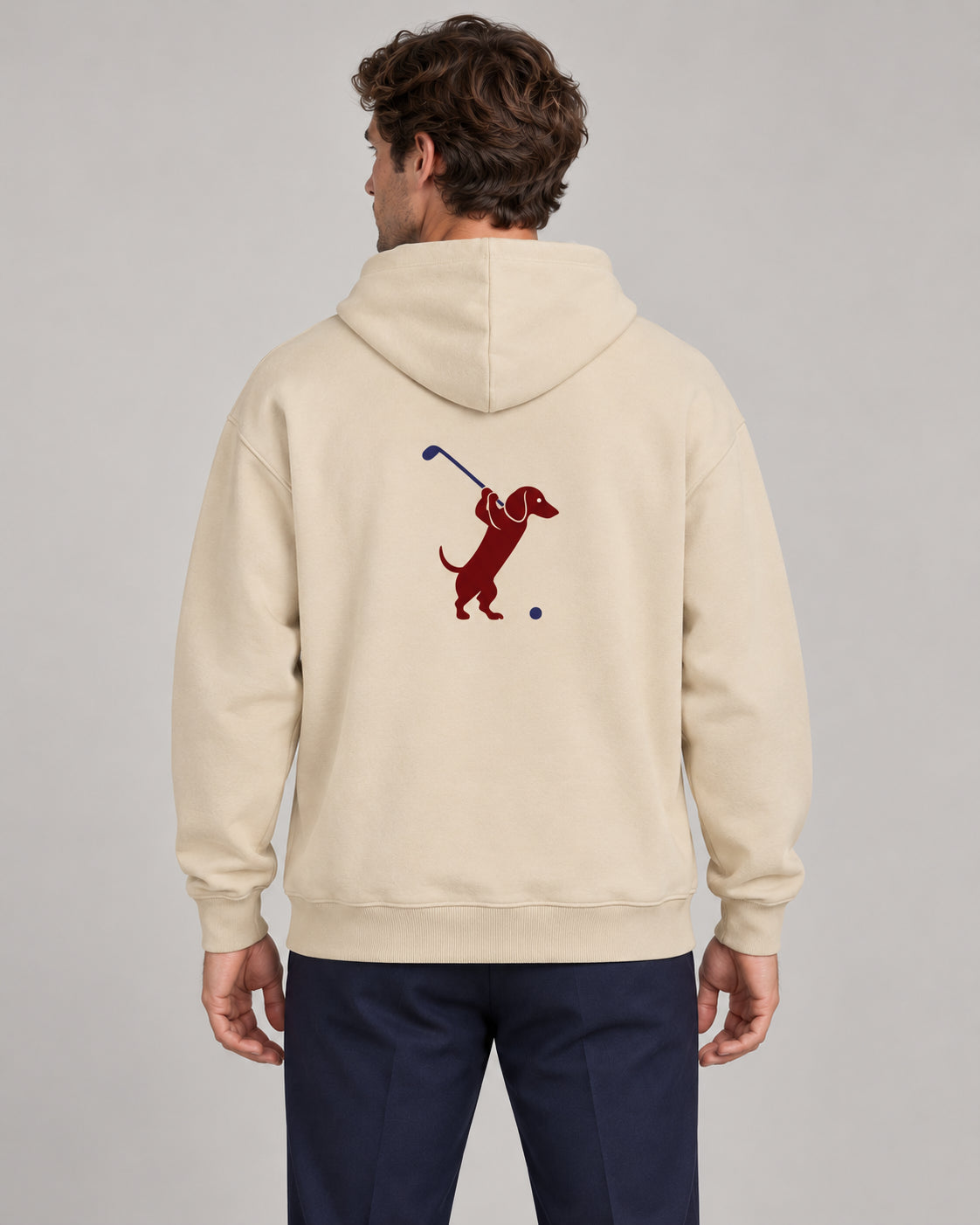 Man wearing Club & Swing dachshund golf hoodie, back studio view. Color: Apricot