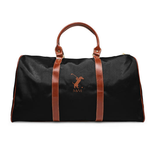 Color: Black. Swing Dachshund golf travel bag in black with a brown swinging dachshund and MVM monogram on the front, brown PU handles, front view.
