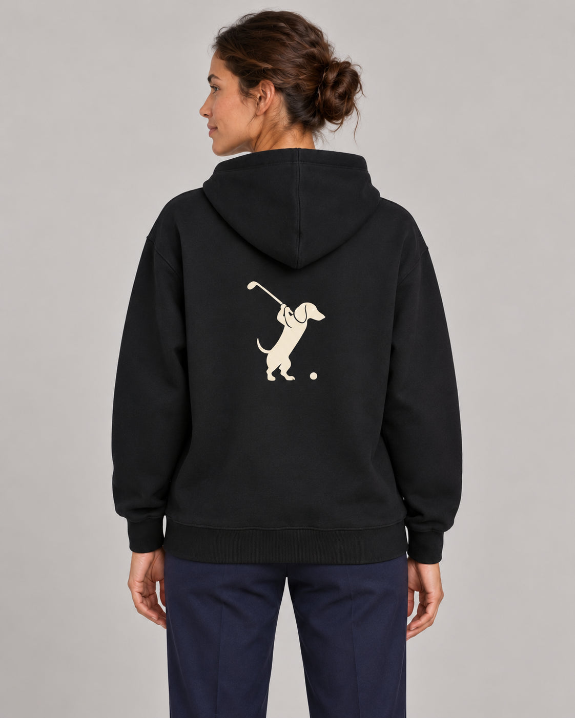 Woman wearing Club & Swing dachshund golf hoodie, back studio view. Color: Black