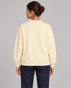 Woman wearing Swing dachshund golf sweatshirt, back studio view. Color: Apricot