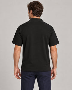 Man wearing Putting dachshund golf polo, back studio view. Color: Black