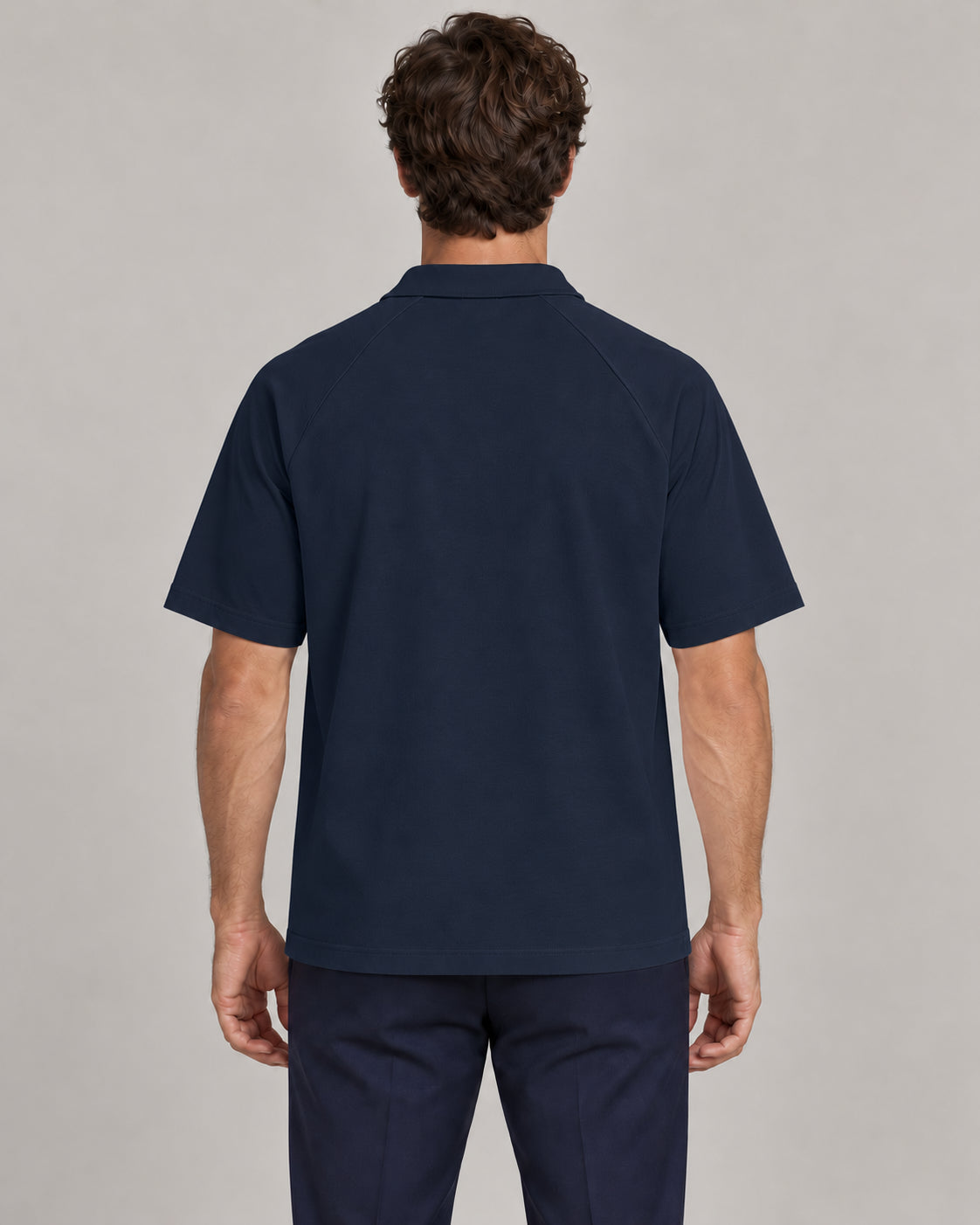 Man wearing Putting dachshund golf polo, back studio view. Color: Navy Blue