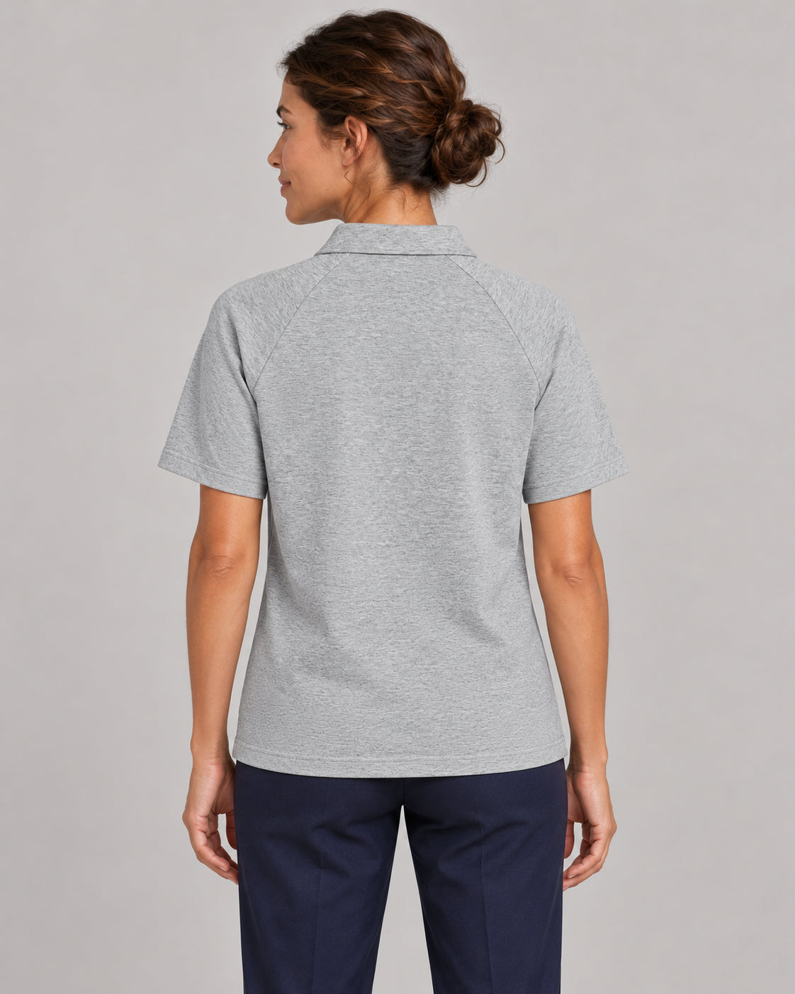 Woman wearing Putting dachshund golf polo, back studio view. Color: Flower Gray