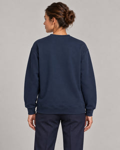 Woman wearing Swing dachshund golf sweatshirt, back studio view. Color: Navy