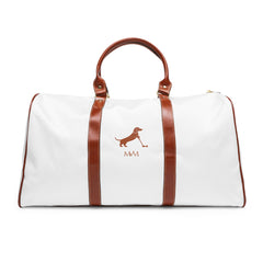 Color: White. Putting Dachshund golf travel bag in white with a brown putting dachshund and MVM monogram on the front, brown PU handles, front view.