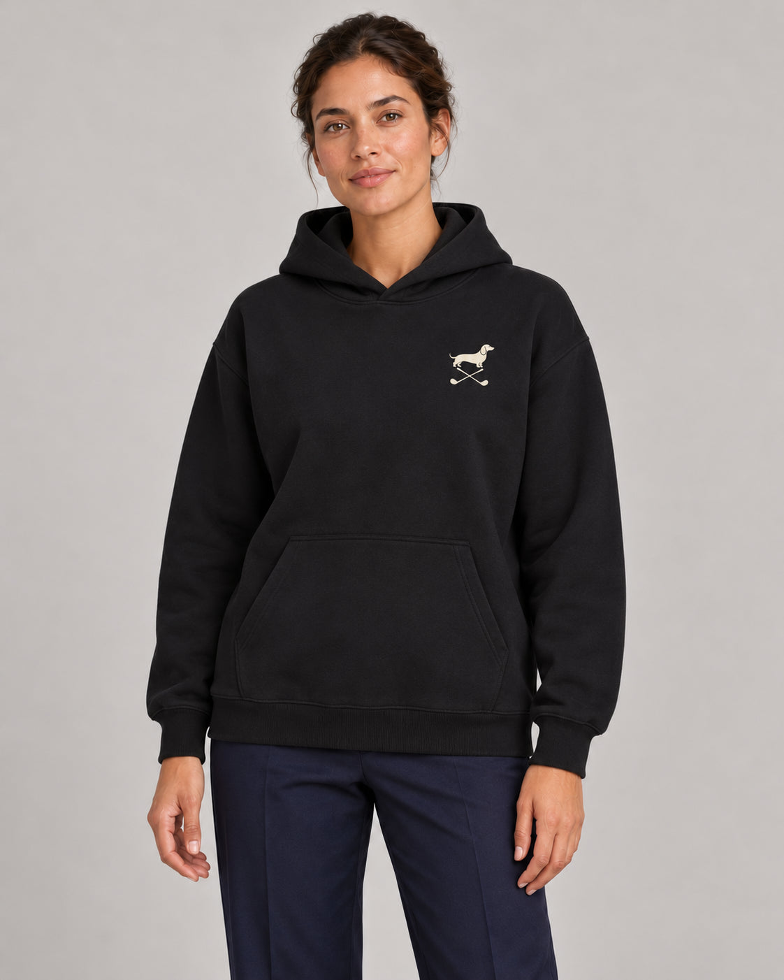 Woman wearing Club & Swing dachshund golf hoodie, front studio view. Color: Black