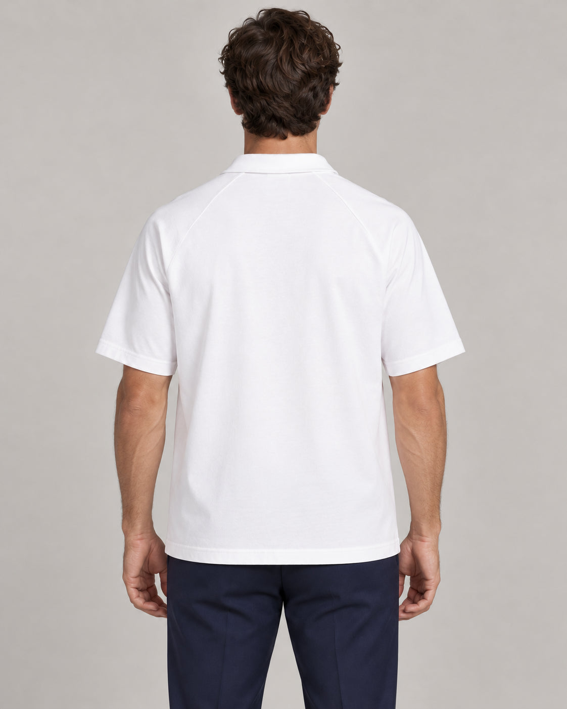 Man wearing Putting dachshund golf polo, back studio view. Color: White