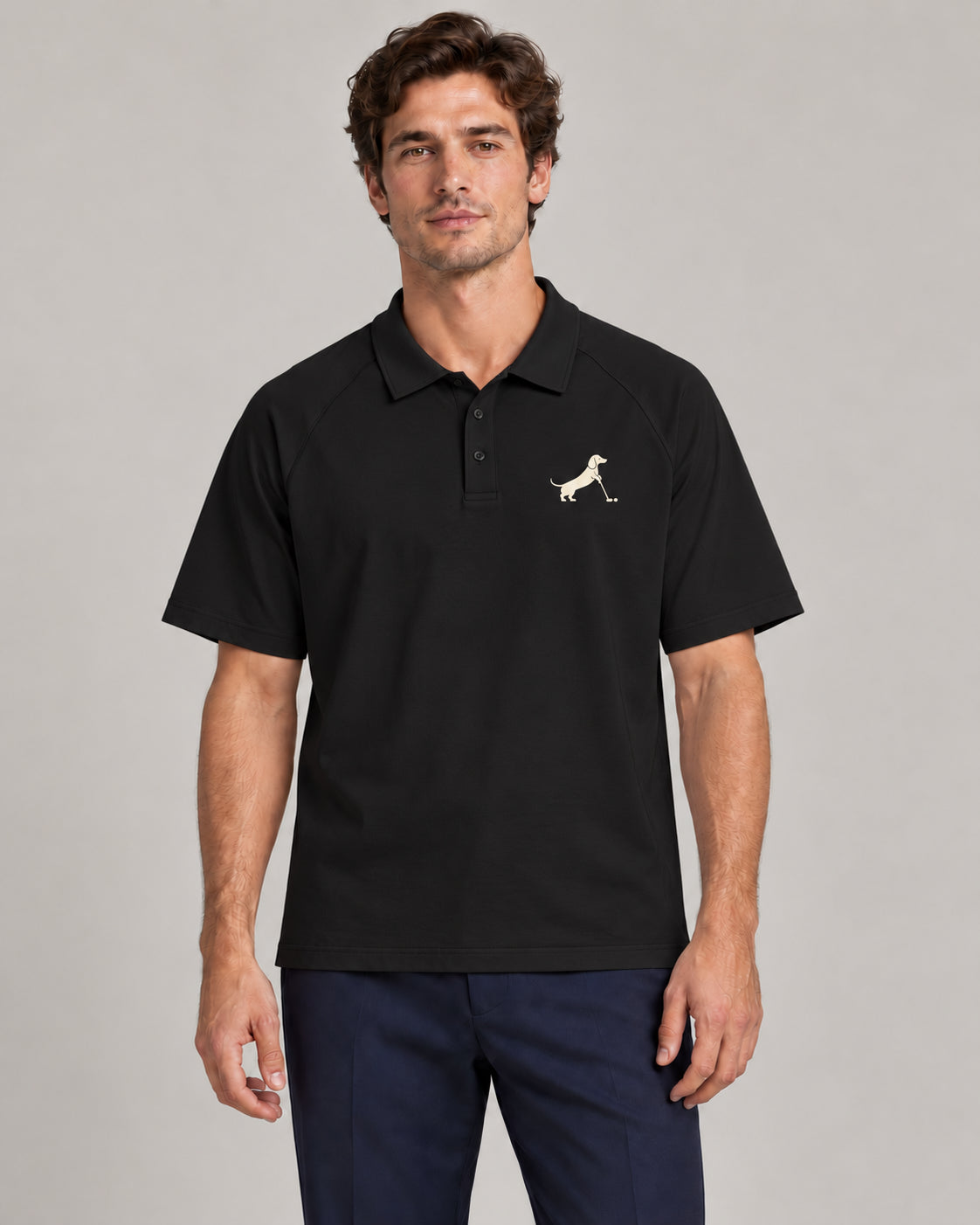Man wearing Putting dachshund golf polo, front studio view. Color: Black