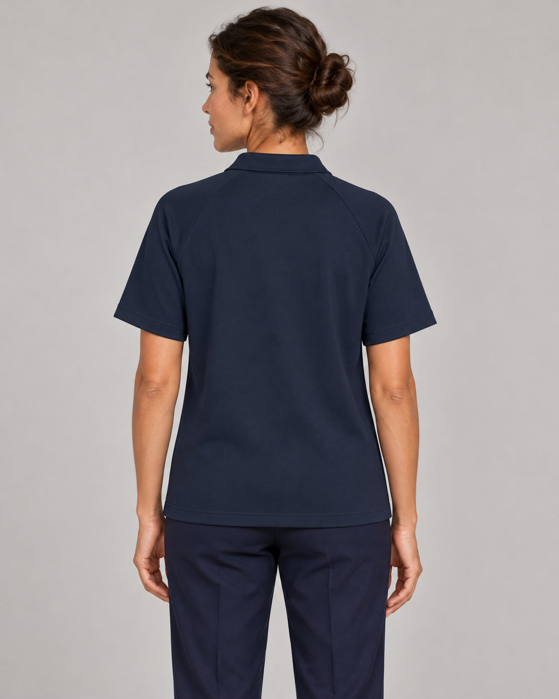 Woman wearing Putting dachshund golf polo, back studio view. Color: Navy Blue