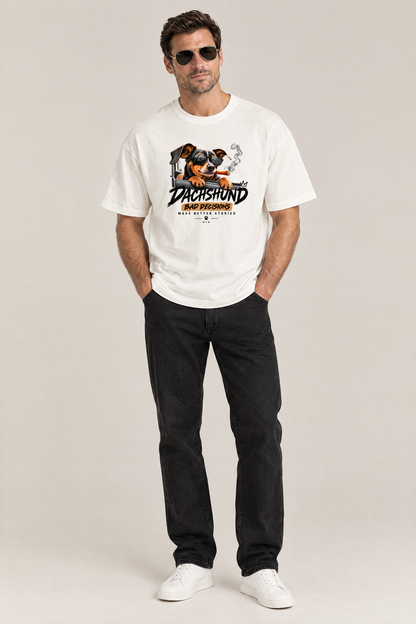 Man in aviator sunglasses wearing the Bad Decisions Dachshund Tee in white with black jeans. Color: White