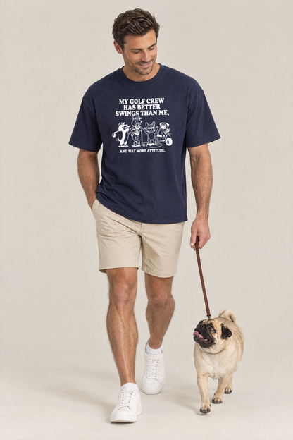 Man walking a pug on a leash in the navy Better Swings Dog Golf Tee. Color: Navy