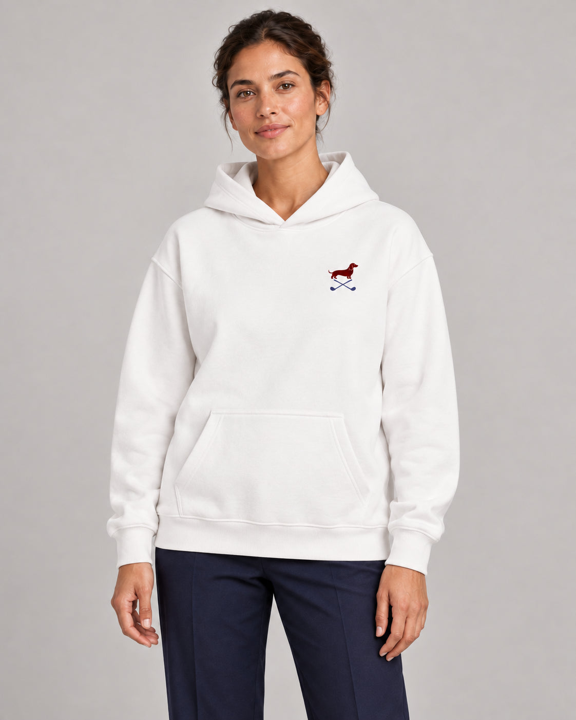 Woman wearing Club & Swing dachshund golf hoodie, front studio view. Color: White