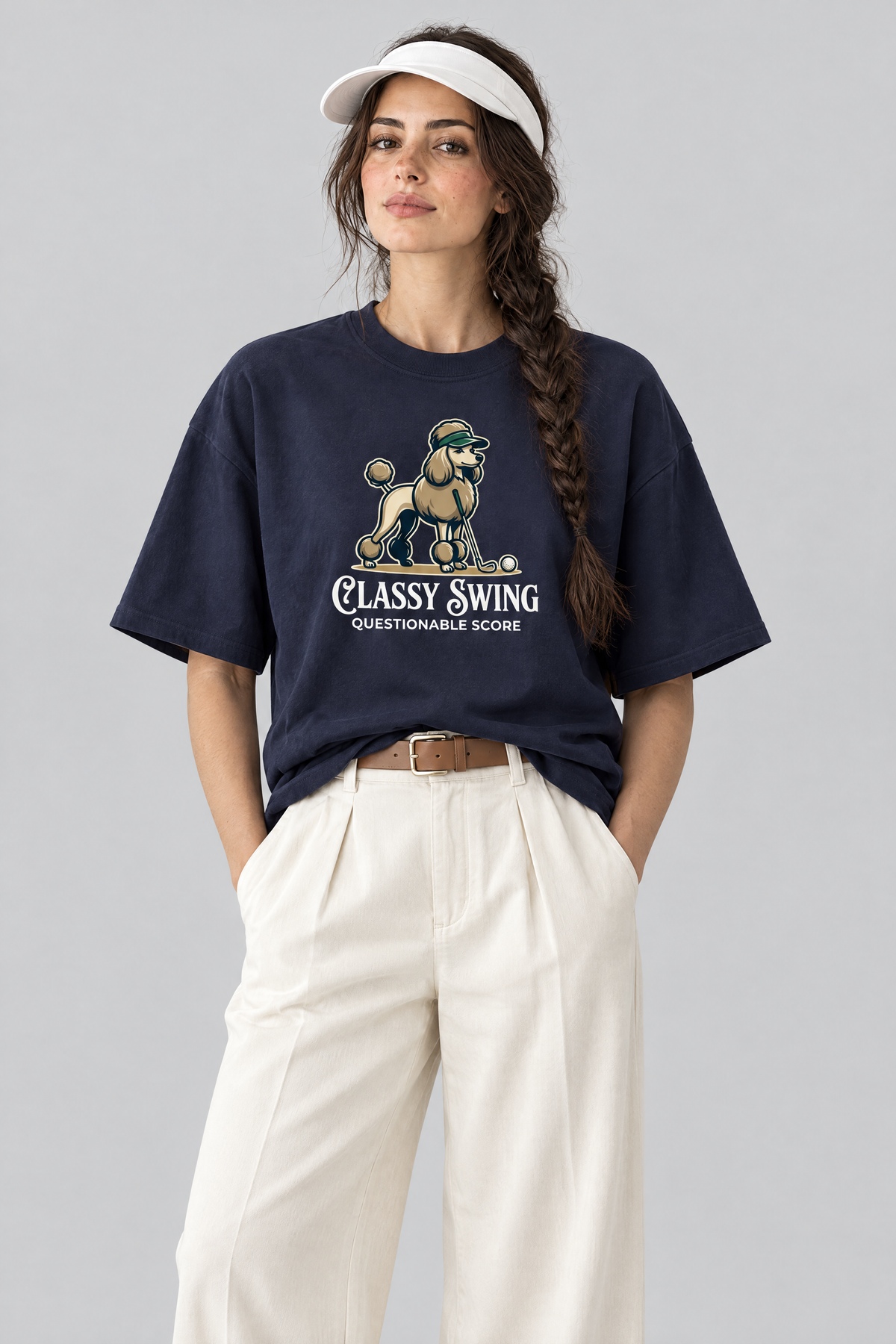 Woman wearing the Classy Swing Poodle Golf Tee with cream wide-leg trousers and a white visor. Color: Navy