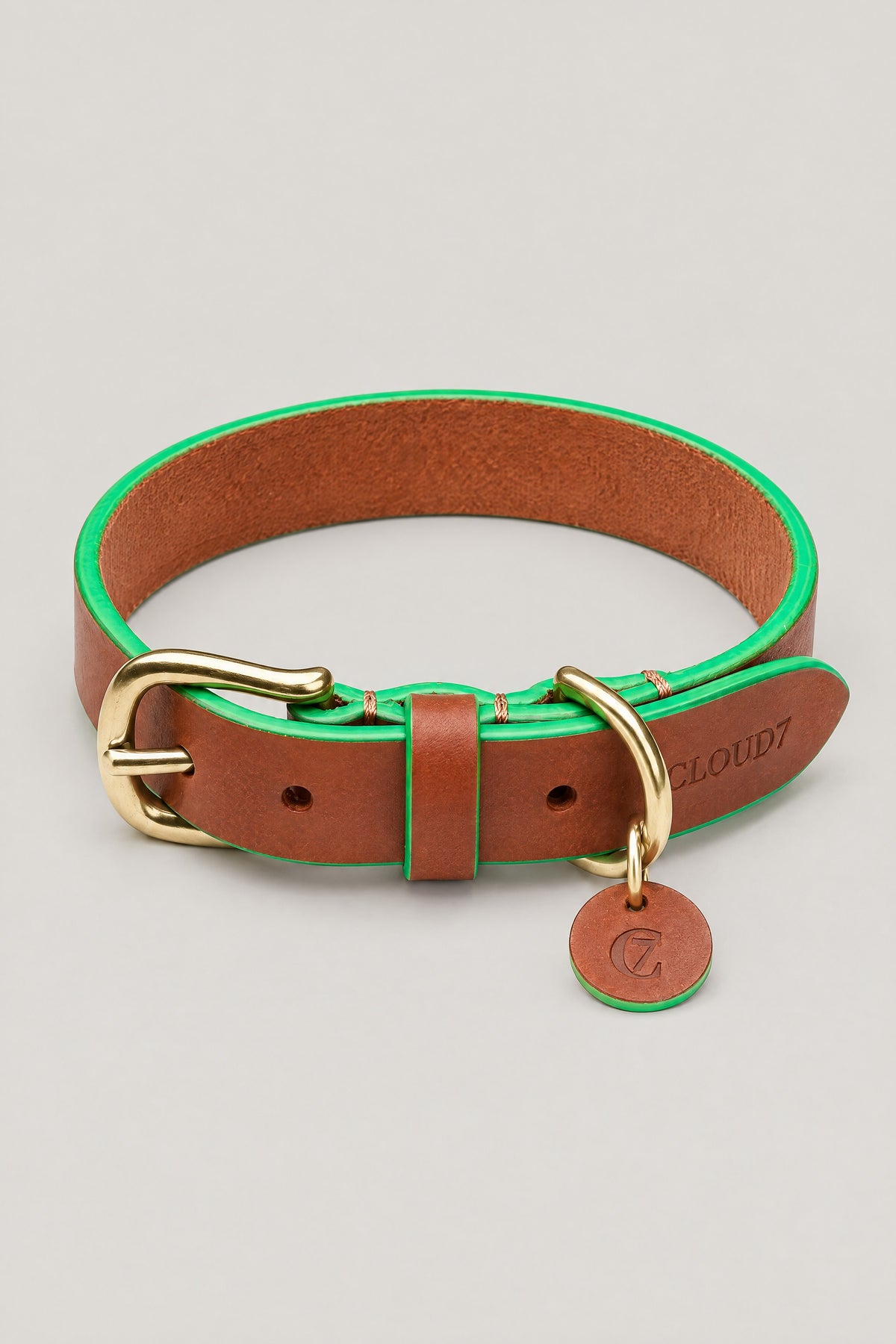 Cognac leather Cloud 7 Kings Park dog collar with green edges, brass buckle and C7 leather tag, front view