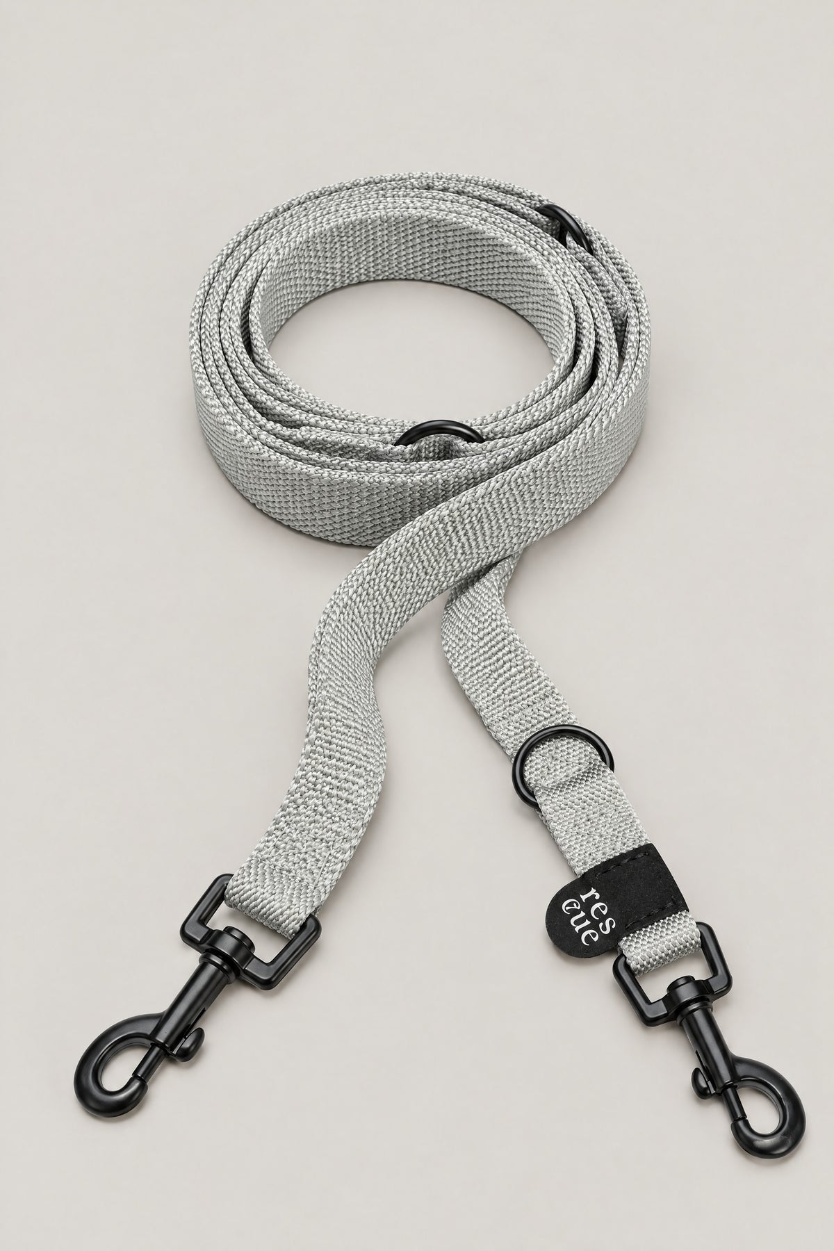 Silver grey nylon Cloud 7 RESC7UE dog leash with black snap hooks and rescue tag, coiled front view
