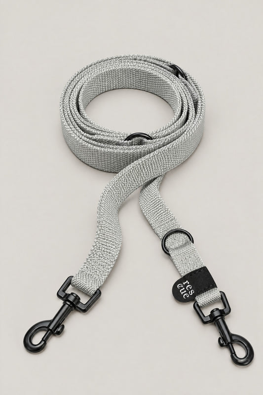 Silver grey nylon Cloud 7 RESC7UE dog leash with black snap hooks and rescue tag, coiled front view