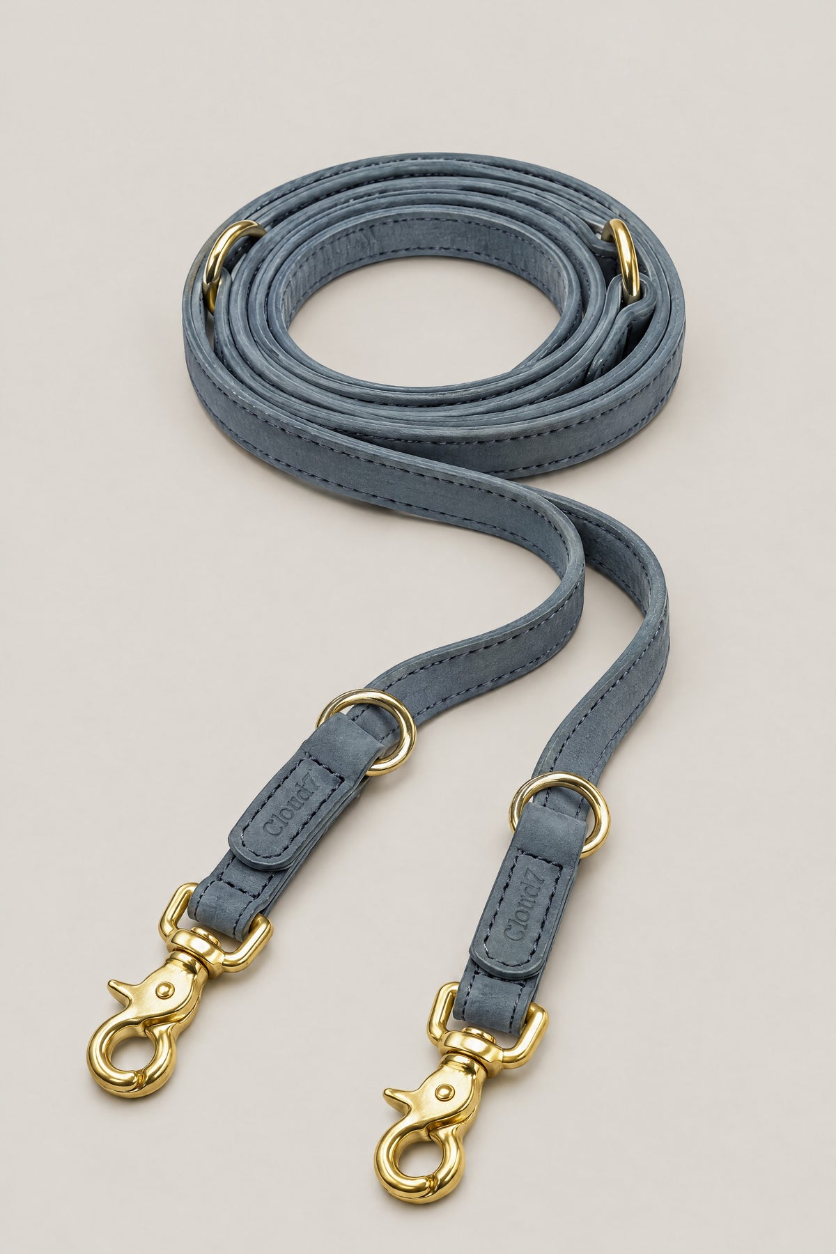 Dove grey nubuck leather Cloud 7 Tiergarten dog leash with brass snap hooks, coiled front view