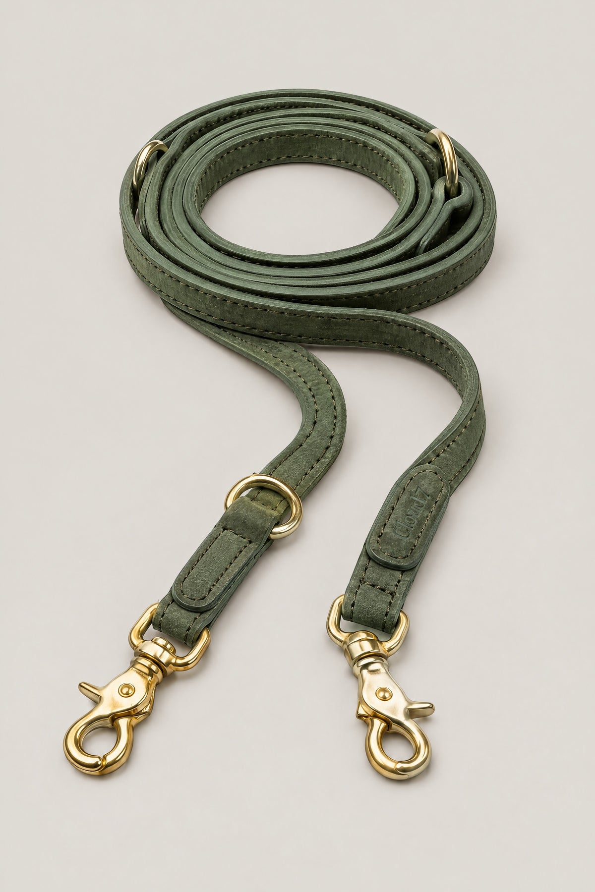 Moss green nubuck leather Cloud 7 Tiergarten dog leash with brass snap hooks, coiled front view