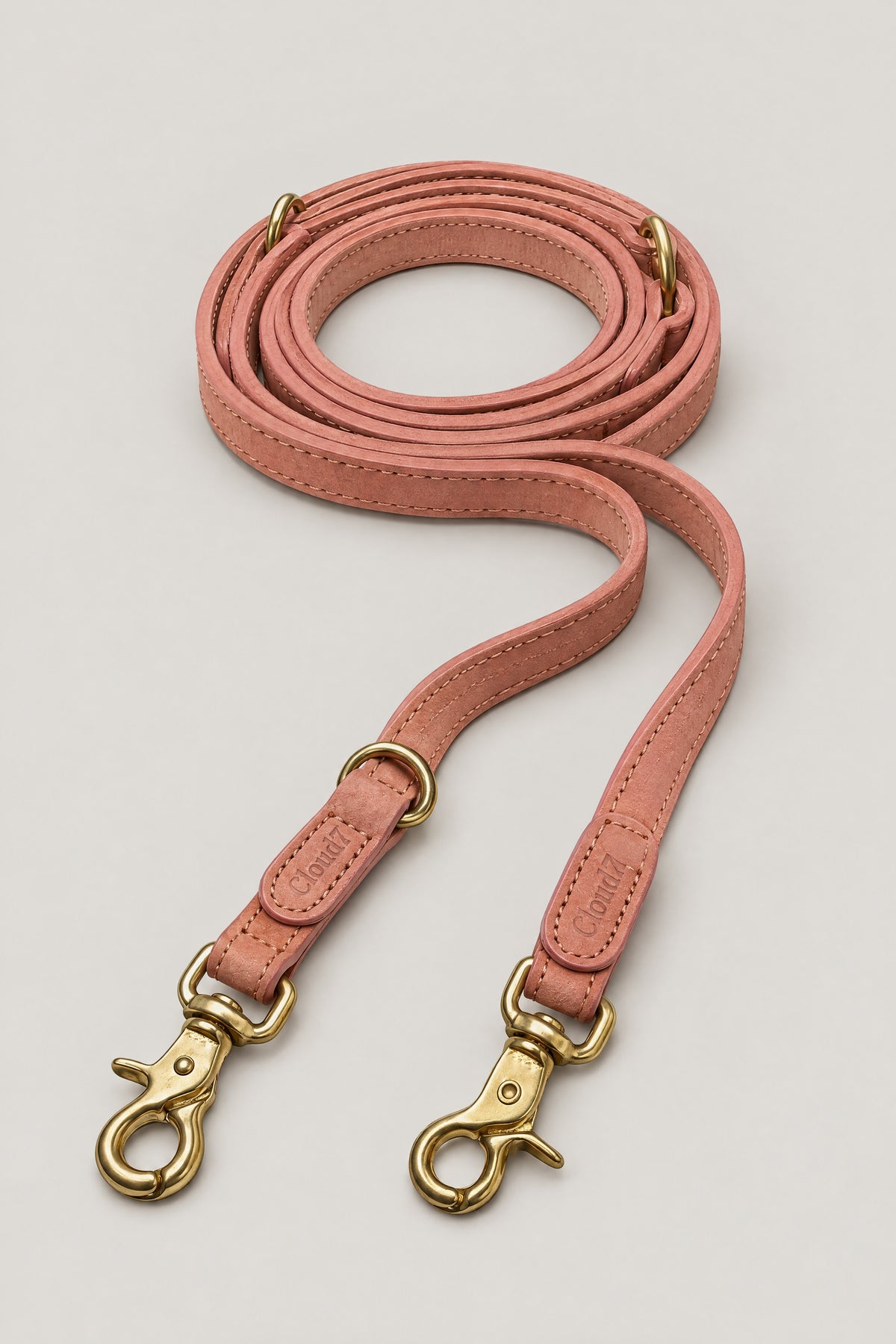 Peach nubuck leather Cloud 7 Tiergarten dog leash with brass snap hooks, coiled front view