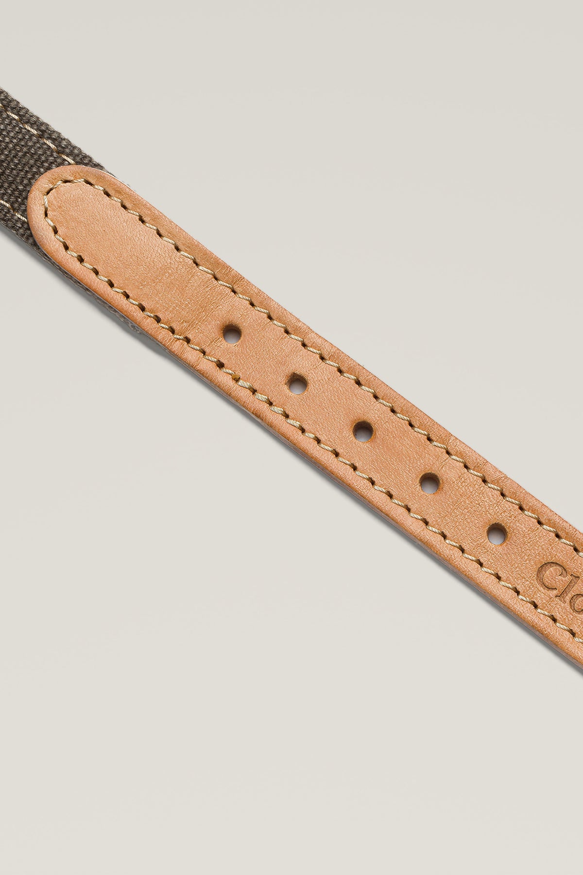 Greige canvas and tan leather end with top stitching of the Cloud 7 Tivoli dog collar, close-up