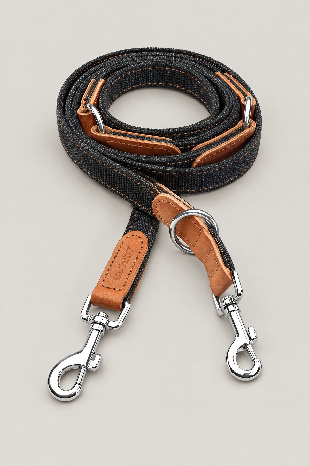Black canvas and cognac leather Cloud 7 Tivoli dog leash with stainless steel snap hooks, coiled front view