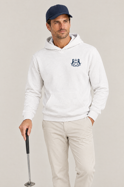 Man holding a putter, wearing the white Club Crest hoodie with the small navy crest on the chest, a navy cap and stone chinos