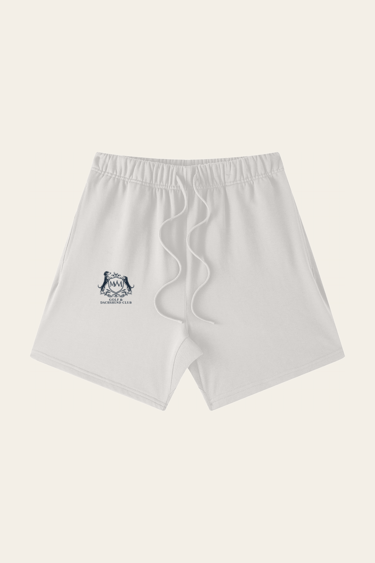 Flat lay of oat gray Club Crest shorts with the small navy Golf & Dachshund Club crest on the leg, front view. Color: Oat Gray