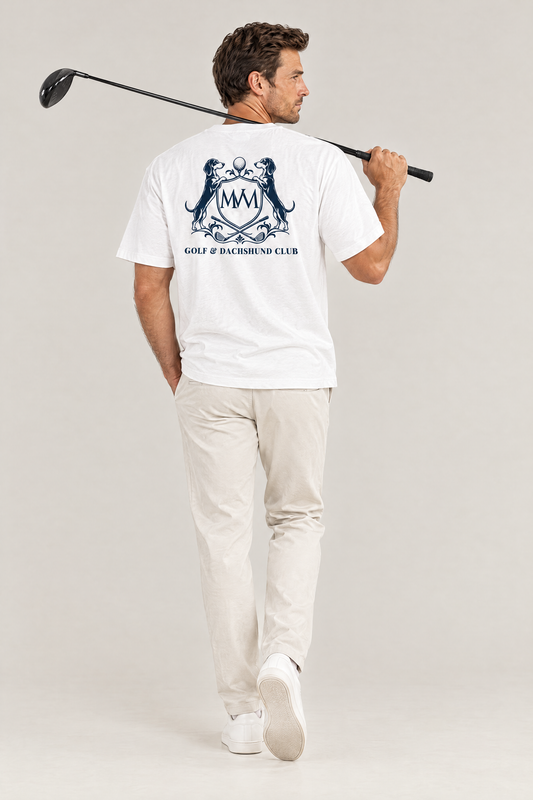 Man with a driver over his shoulder, back view of the white Club Crest tee with the large navy Golf & Dachshund Club crest