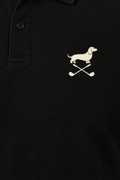 Close-up of the collar and chest logo on the black Club Mark dachshund golf polo. Color: Black
