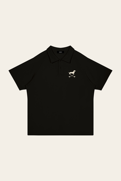 Black Club Mark dachshund golf polo laid flat, front view on warm off-white background. Color: Black