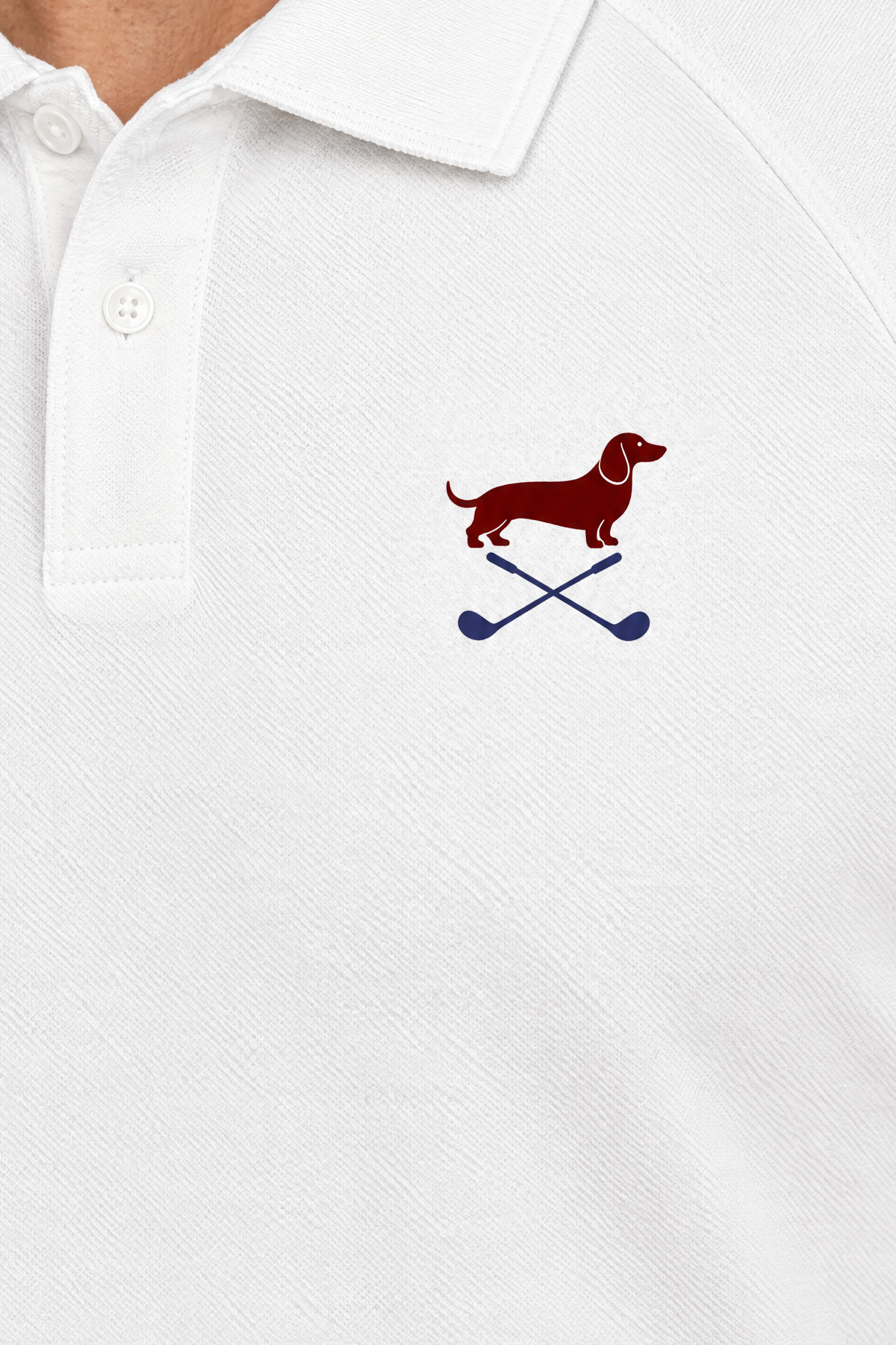 Close-up of the collar and chest logo on the white Club Mark dachshund golf polo. Color: White