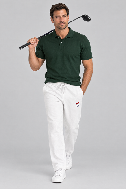 Man walking with a driver over his shoulder in white Club Mark dachshund golf sweatpants and a dark green polo. Color: White